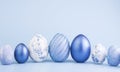 Chicken eggs painted in blue on a blue background. Creative card with Easter. Copy space Royalty Free Stock Photo