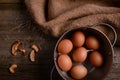 Chicken eggs in pan on rustic wooden background with burlap straw Royalty Free Stock Photo
