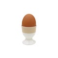 Chicken eggs placed in ceramic cups on white background