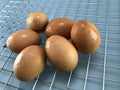 Chicken eggs placed on a metal sieve