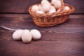 Chicken eggs in shell and in a wicker basket Royalty Free Stock Photo