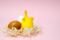 Chicken eggs and toy chicken on pink background. Easter concept. Top view Royalty Free Stock Photo