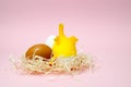 Chicken eggs and toy chicken on pink background. Easter concept. Top view Royalty Free Stock Photo