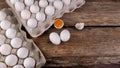 Chicken eggs in trays, next to which separately two eggs and one broken, place for text Royalty Free Stock Photo