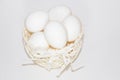 Chicken eggs in a white basket on a white background Royalty Free Stock Photo