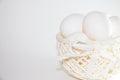 Chicken eggs in a white basket on a white background Royalty Free Stock Photo