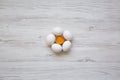 Chicken eggs on white wooden table, top view.