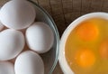 Chicken eggs, Yolk in a ceramic dish on a wooden background, top view Royalty Free Stock Photo