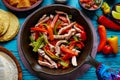 Chicken fajitas in a pan chili and sides Mexican Royalty Free Stock Photo