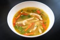 Chicken Feet Spicy Soup - Chicken Foot with hot and sour soup bowl with fresh vegetables Tom Yum thai herbs and spices ingredients Royalty Free Stock Photo