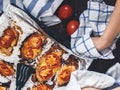 Chicken fillet baked with tomatoes and cheese on a baking sheet