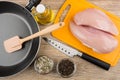 Chicken fillet on cutting board, vegetable oil, spices, frying p Royalty Free Stock Photo