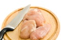 Chicken fillet and knife on hardboard isolated Royalty Free Stock Photo