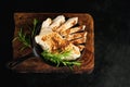 Semi-finished chicken fillets,lightly fried,on a dark background .Half-finished.Quick cooking at home.Fast food.Chicken