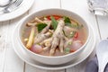 Chicken foot tom yum soup served in a white bowl