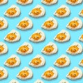 Chicken fried egg sprinkled with herbs isolated on blue background. Scrambled eggs close-up seamless pattern. Royalty Free Stock Photo