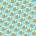 Chicken fried egg sprinkled with herbs isolated on blue background. Scrambled eggs close-up seamless pattern. Royalty Free Stock Photo