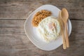 Chicken fried garlic and egg fried with cooked rice on wood table Royalty Free Stock Photo