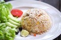 Chicken fried rice with lettuce salad cucumber lemon and grape on white dish Royalty Free Stock Photo