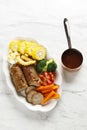 Chicken galantine, sliced, served on white plate with bbq sauce and vegetables. Selective focus Royalty Free Stock Photo