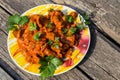 Chicken gizzard stew in plate on rustic wooden table Royalty Free Stock Photo