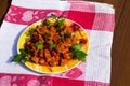 Chicken gizzard stew in plate on rustic wooden table Royalty Free Stock Photo