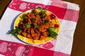 Chicken gizzard stew in plate on rustic wooden table Royalty Free Stock Photo