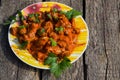 Chicken gizzard stew in plate on rustic wooden table Royalty Free Stock Photo