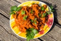 Chicken gizzard stew in plate on rustic wooden table Royalty Free Stock Photo