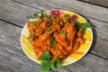 Chicken gizzard stew in plate on rustic wooden table Royalty Free Stock Photo