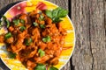 Chicken gizzard stew in plate on rustic wooden table Royalty Free Stock Photo