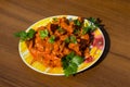 Chicken gizzard stew in plate on wooden table Royalty Free Stock Photo