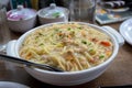 Chicken gravy noodles or chowmein served in a white bowl over moody background. Selective focus