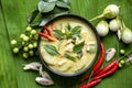 Chicken green curry Thai food on soup bowl with ingredient vegetable herbs and spices pepper chili on banana leaf background, Royalty Free Stock Photo