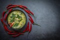 Chicken green curry Thai food on soup bowl with ingredient vegetable herbs and spices pepper chili dark background, Traditional Royalty Free Stock Photo