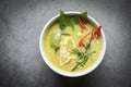 Chicken green curry Thai food on soup bowl with ingredient vegetable herbs and spices pepper chili dark background, Traditional Royalty Free Stock Photo