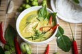 Chicken green curry Thai food on soup bowl with rice noodles ingredient vegetable herbs and spices pepper chili wooden background Royalty Free Stock Photo