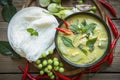 Chicken green curry Thai food on soup bowl with rice noodles ingredient vegetable herbs and spices pepper chili wooden background Royalty Free Stock Photo