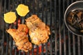 chicken with greens and vegetables roasting on a charcoal barbecue lit wood with fire for roasting chicken on the grill Royalty Free Stock Photo