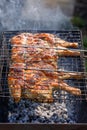 Chicken grilled on a charcoal barbeque brazier
