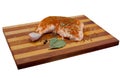 Chicken ham is sprinkled with spices and bay leaf on wooden, bamboo cutting board. Royalty Free Stock Photo