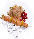 Chicken kebab with rice and vegetables on a white background on a transparent plate decoratet with glass stones