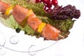 Chicken kebab with rice and vegetables on a white background on a transparent plate decoratet with glass stones