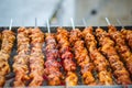 Chicken kebabs cooking on a charcoal grill
