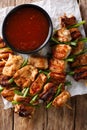 Chicken kebabs with green onions in a spicy sauce - Dakkochi close-up. Vertical top view