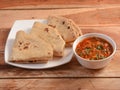 Chicken Kheema / Curry, with Tava Roti, Indian FlatBread, served over a rustic wooden table, selective focus