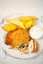 Chicken kiev with basil pesto, potato chips and mayo dip Royalty Free Stock Photo