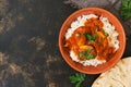 Chicken korma with a spicy sauce over white rice.Traditional Indian dish on a rustic background. Top view, copy space. Royalty Free Stock Photo