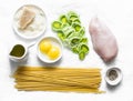 Chicken, leek, linguine pasta, parmesan cheese, eggs yolks, olive oil - ingredients for cooking carbonara pasta on a light Royalty Free Stock Photo