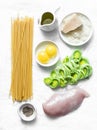 Chicken, leek, linguine pasta, parmesan cheese, eggs yolks, olive oil - ingredients for cooking carbonara pasta on a light Royalty Free Stock Photo